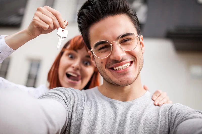Two happy first-time home buyers celebrated a property obtained with help from a mortgage broker